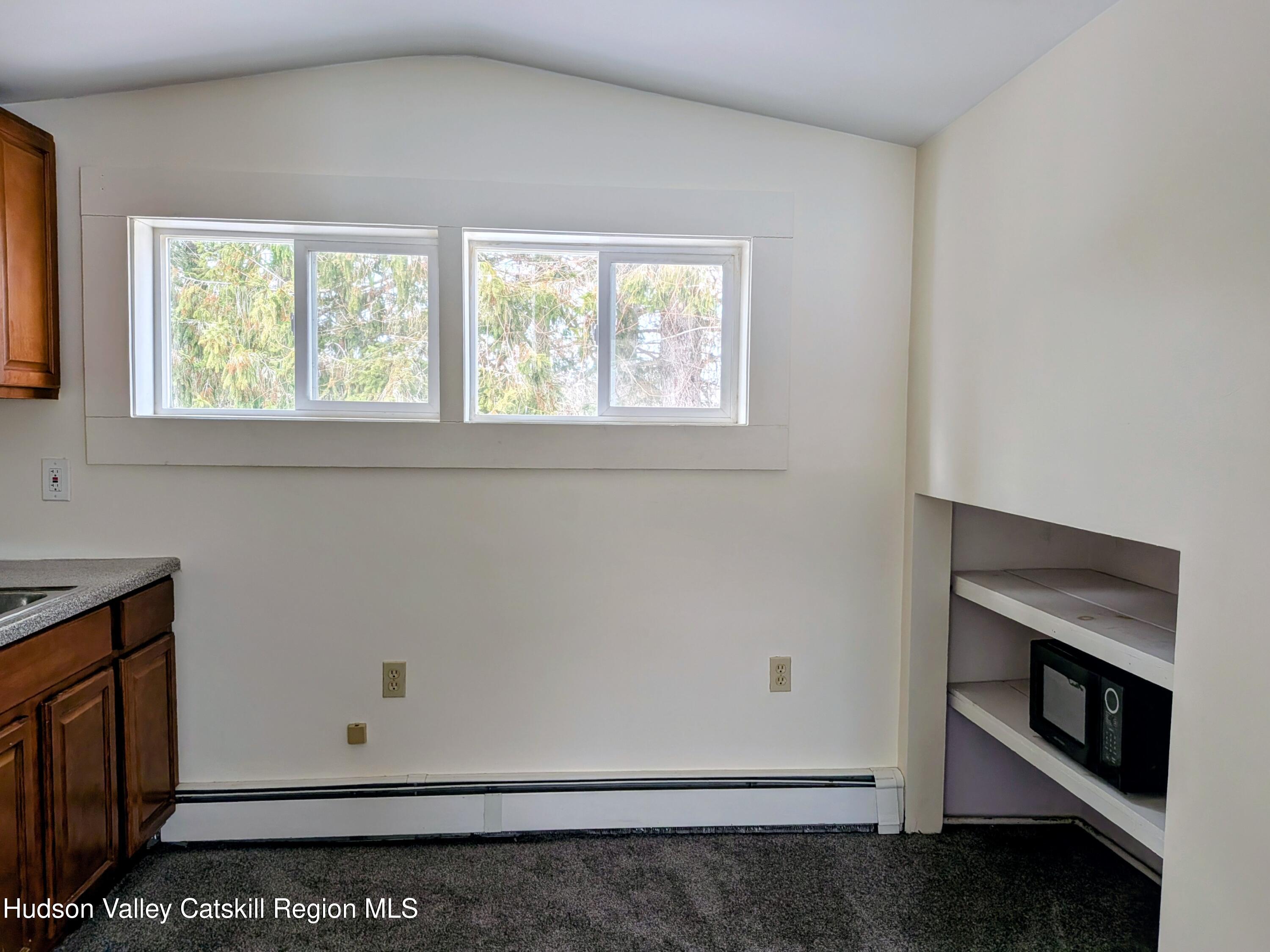 351 Presbyterian Hill Road Stephentown, NY 12168 - Photo 38 of 46 an empty room with wooden floor and window