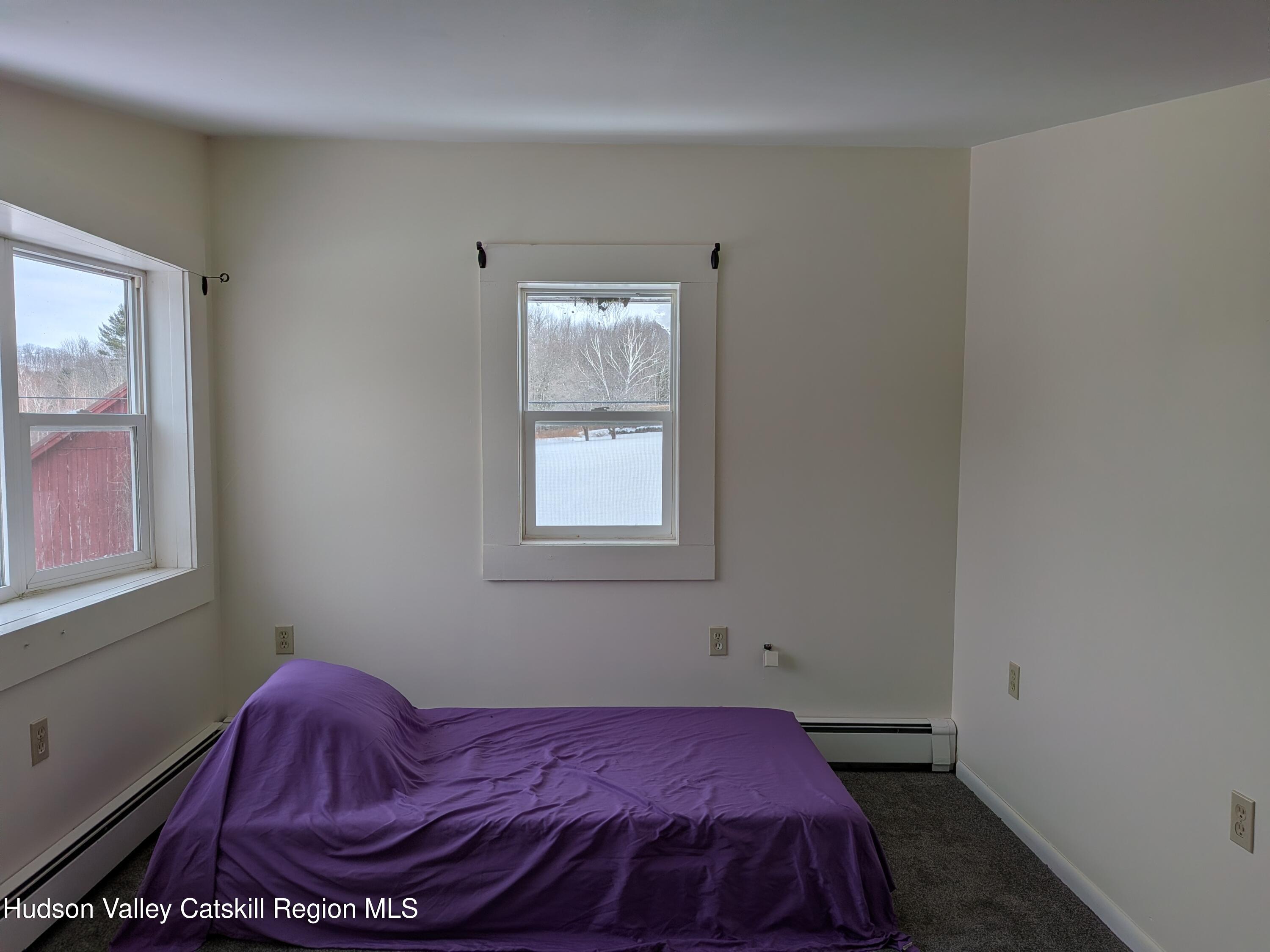 351 Presbyterian Hill Road Stephentown, NY 12168 - Photo 39 of 46 a bedroom with a bed and window