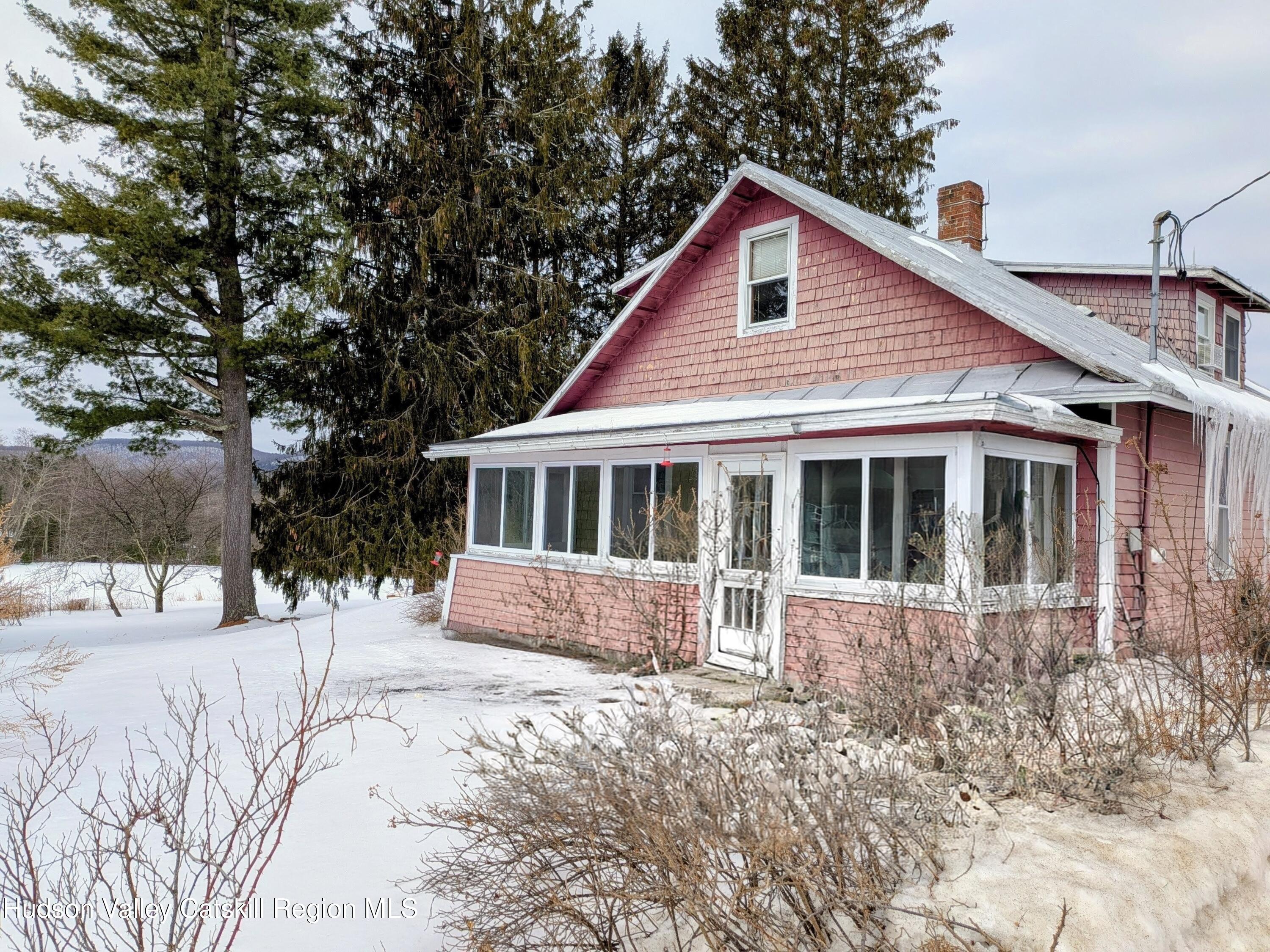 351 Presbyterian Hill Road Stephentown, NY 12168 - Photo 5 of 46 a front view of a house with a yard covered with snow