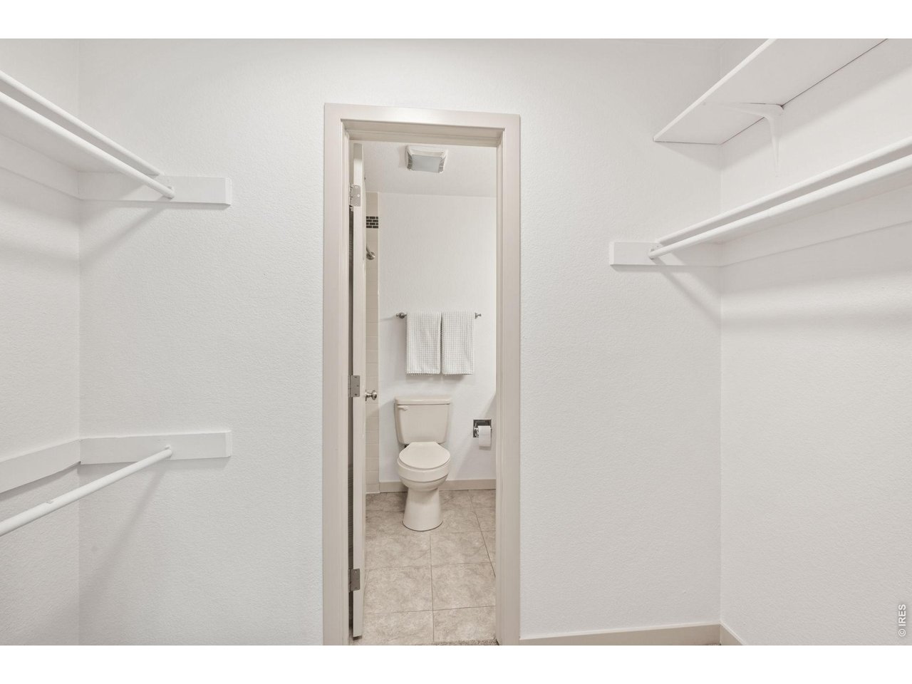 7422 Clubhouse Road Boulder, CO 80301 - Photo 15 of 25 Primary walk-in closet leads to primary en suite bathroom