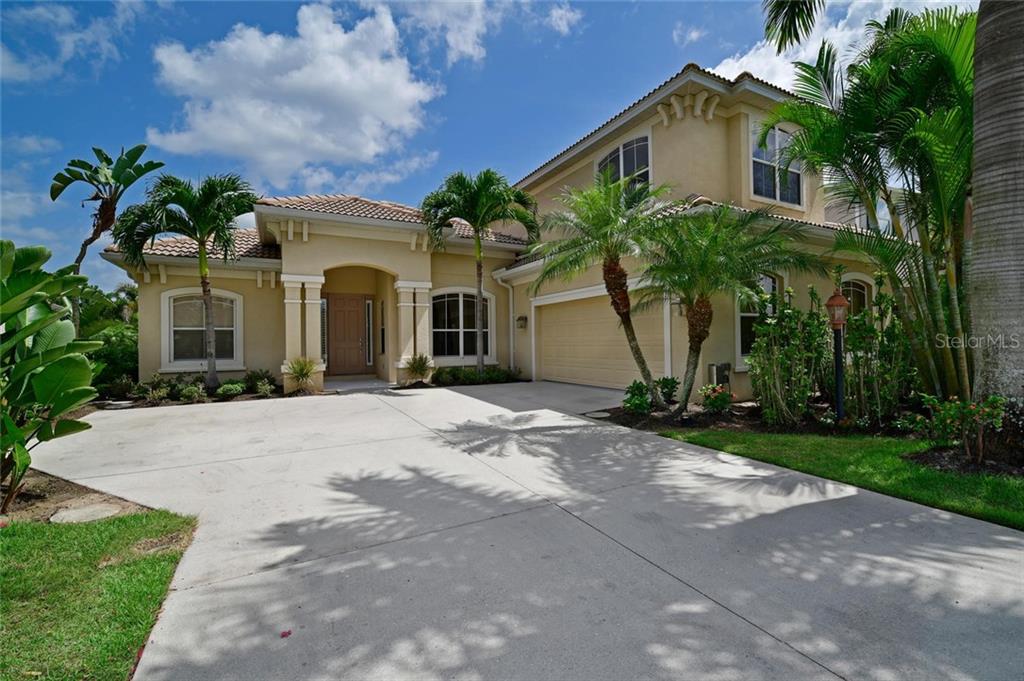 14238 Sundial Place Lakewood Ranch, FL 34202 - Photo 1 of 1 a front view of a house with a yard and garage
