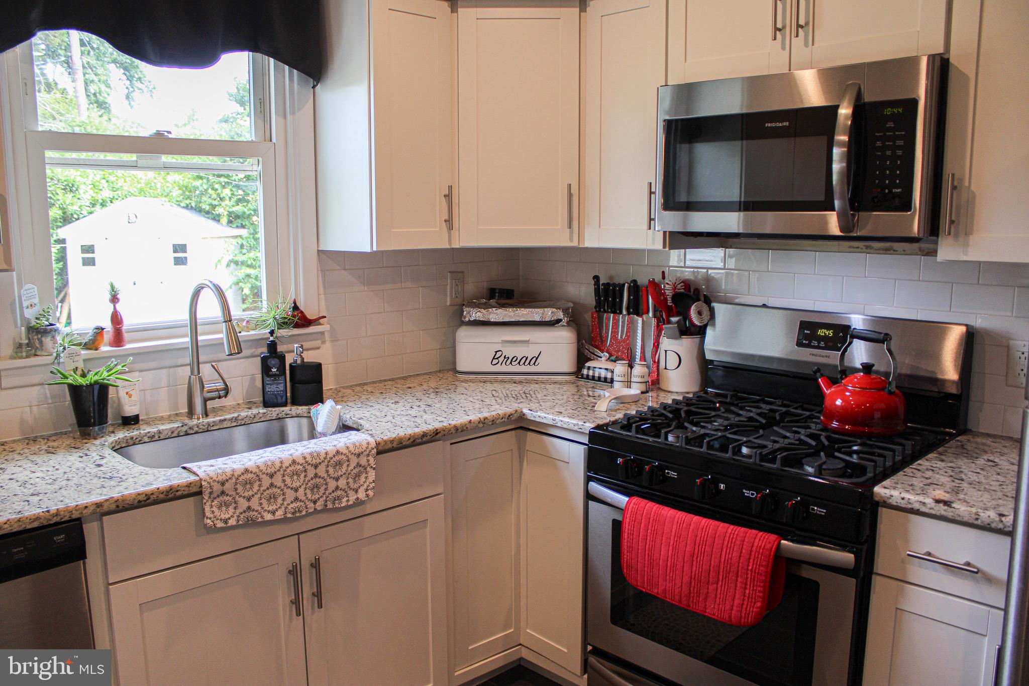 963 Windsor Road Warminster, PA 18974 - Photo 11 of 36 a kitchen with stainless steel appliances granite countertop a stove a sink and a microwave