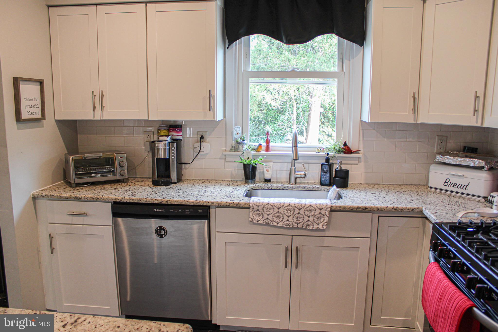 963 Windsor Road Warminster, PA 18974 - Photo 12 of 36 a kitchen with granite countertop white cabinets and window