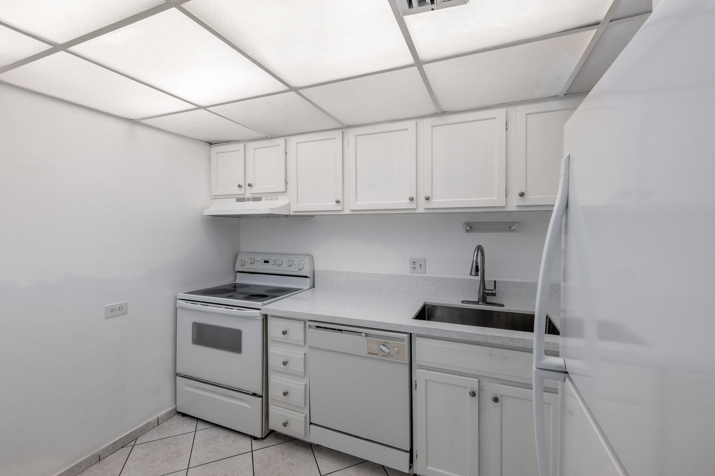 3660 Inverrary Drive, Unit 3Q Lauderhill, FL 33319 - Photo 12 of 35 a kitchen with stainless steel appliances granite countertop a sink and cabinets