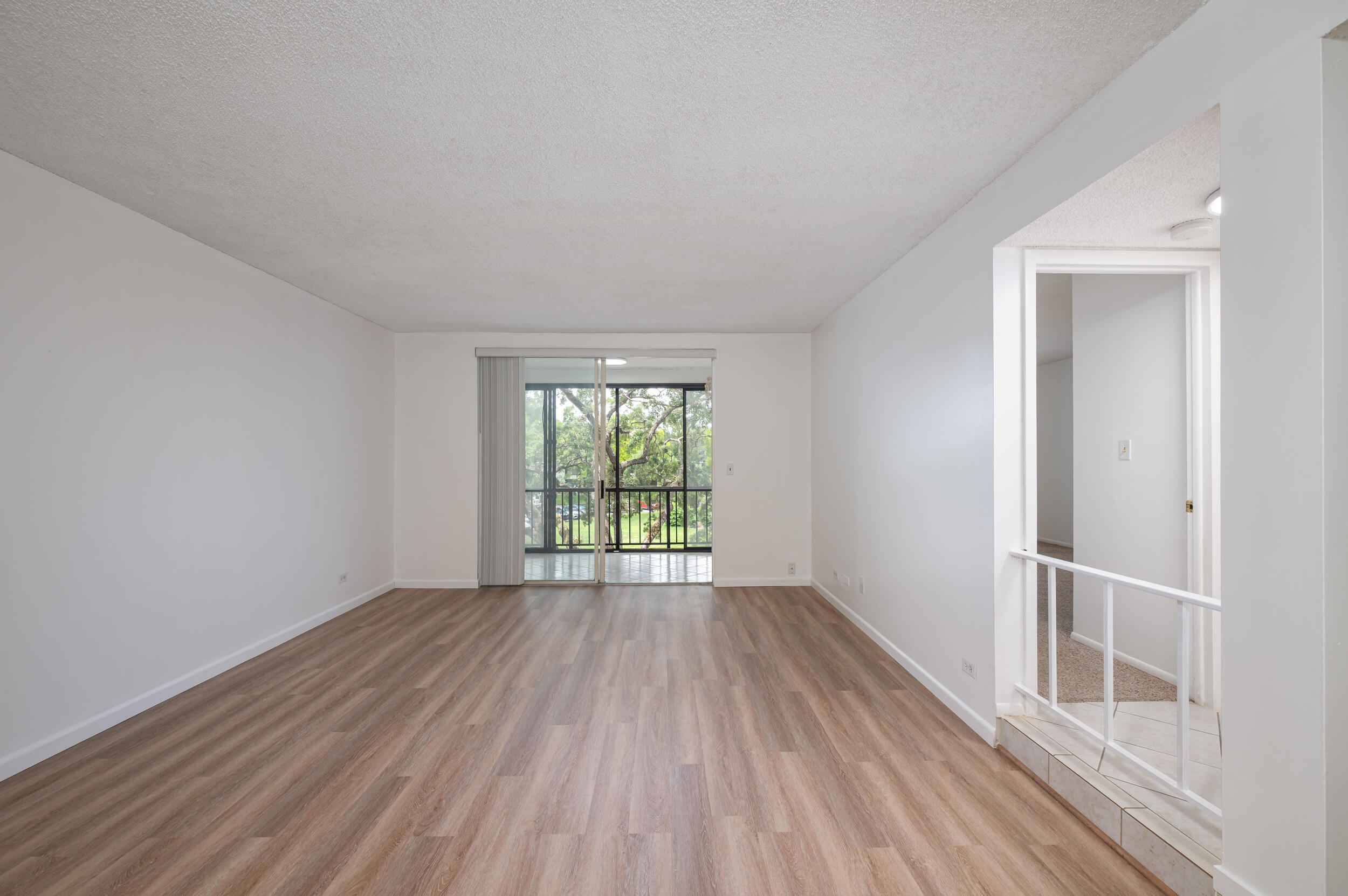 3660 Inverrary Drive, Unit 3Q Lauderhill, FL 33319 - Photo 15 of 35 wooden floor in an empty room with a window