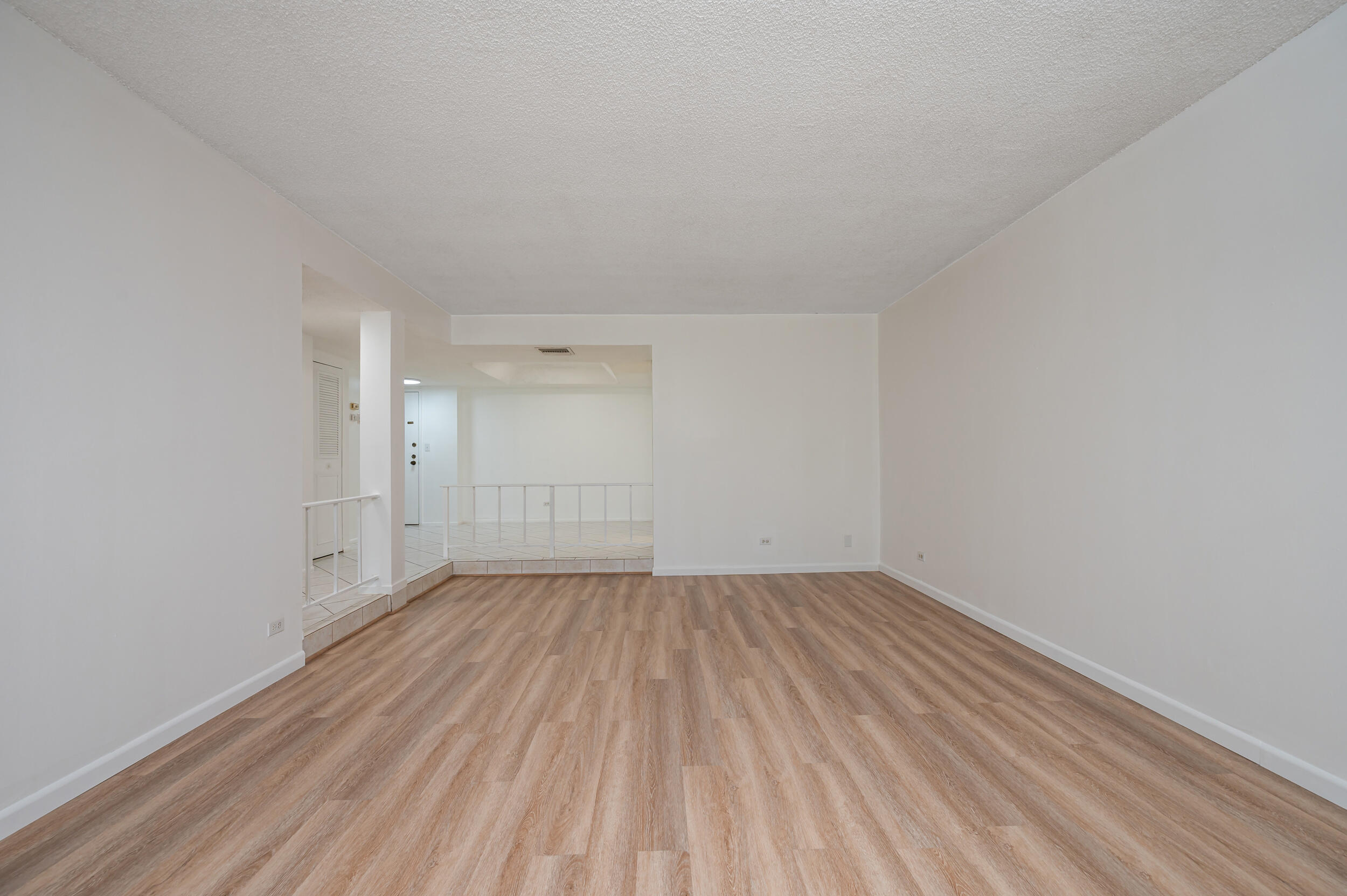 3660 Inverrary Drive, Unit 3Q Lauderhill, FL 33319 - Photo 16 of 35 a view of an empty room with wooden floor