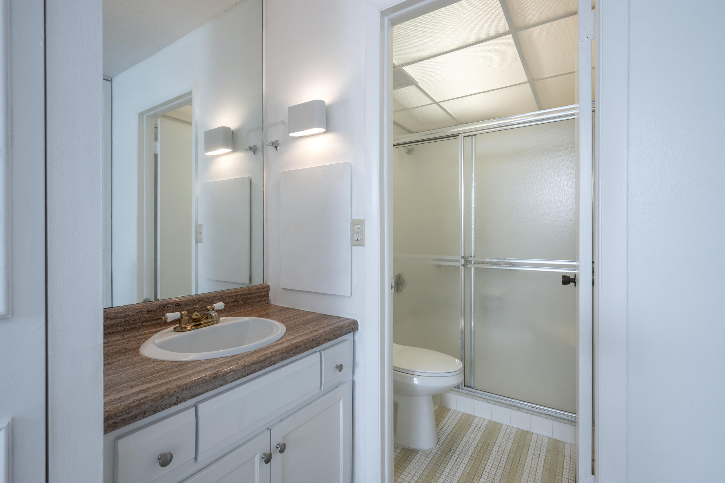 3660 Inverrary Drive, Unit 3Q Lauderhill, FL 33319 - Photo 21 of 35 a bathroom with a granite countertop sink toilet and shower