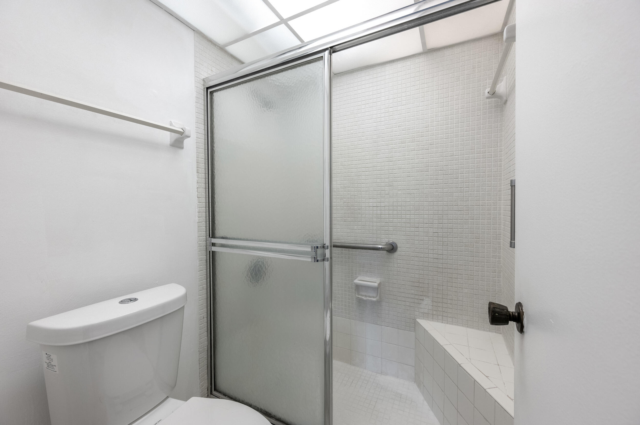 3660 Inverrary Drive, Unit 3Q Lauderhill, FL 33319 - Photo 23 of 35 a bathroom with a shower and toilet