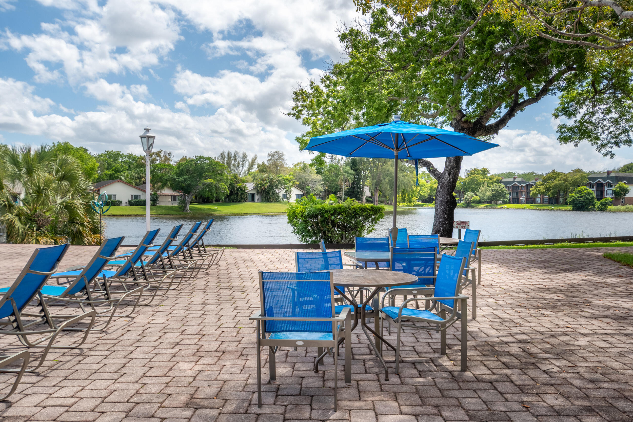 3660 Inverrary Drive, Unit 3Q Lauderhill, FL 33319 - Photo 33 of 35 an outdoor space with furniture and umbrella