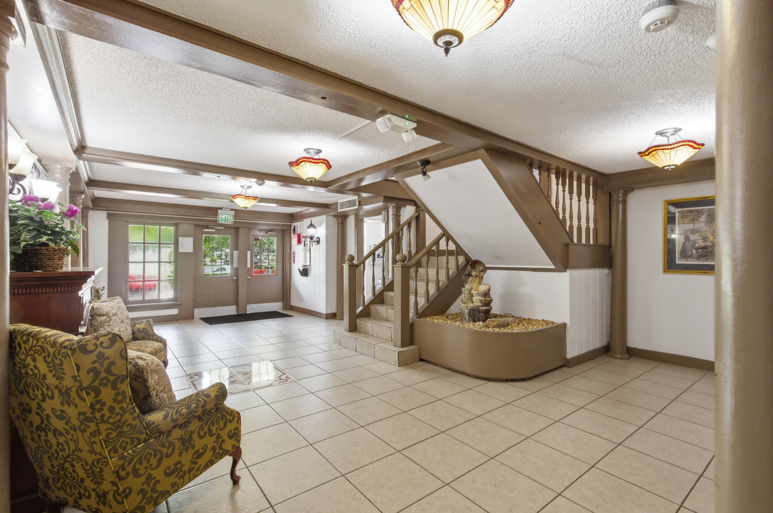 3660 Inverrary Drive, Unit 3Q Lauderhill, FL 33319 - Photo 5 of 35 a living room with furniture and stairs