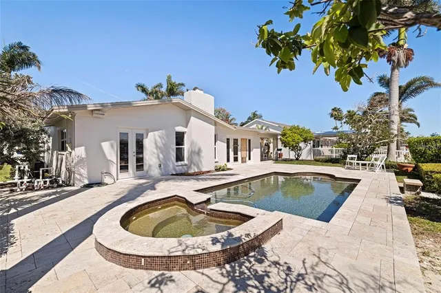a view of a house with swimming pool and sitting area