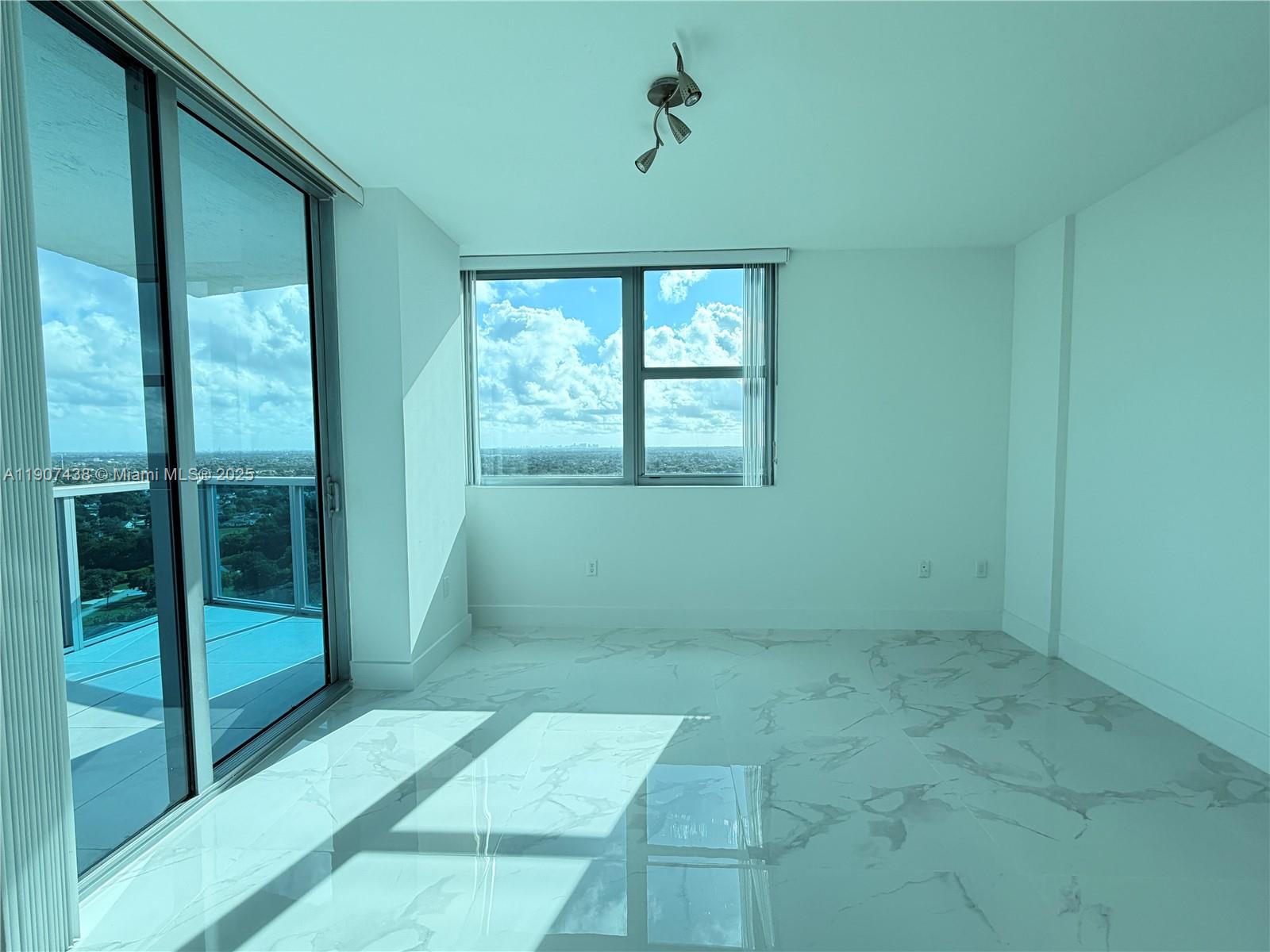 2641 North Flamingo Road, Unit 2208N Sunrise, FL 33323 - Photo 11 of 56 a view of an empty room with glass door