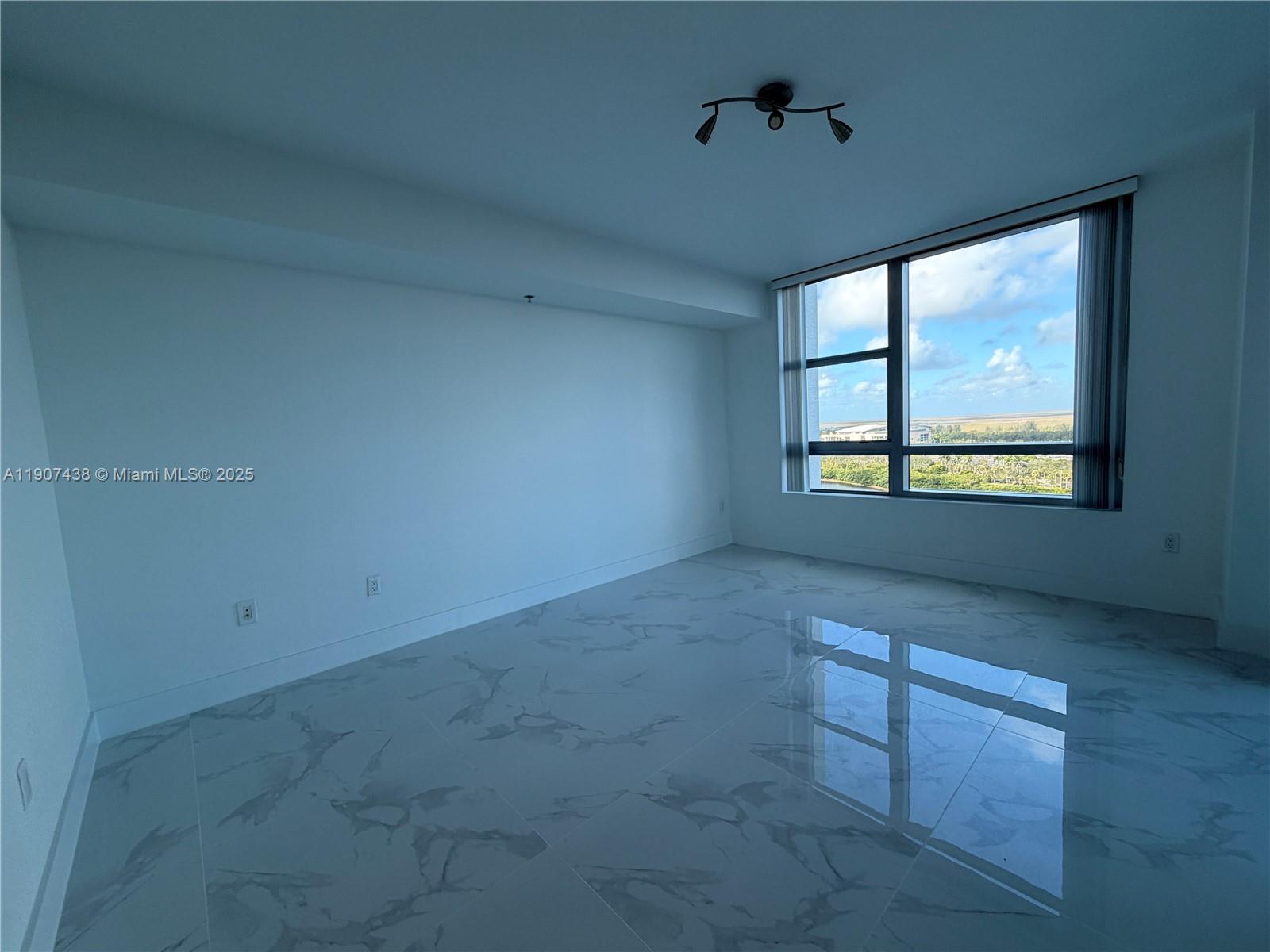 2641 North Flamingo Road, Unit 2208N Sunrise, FL 33323 - Photo 12 of 56 an empty room with windows