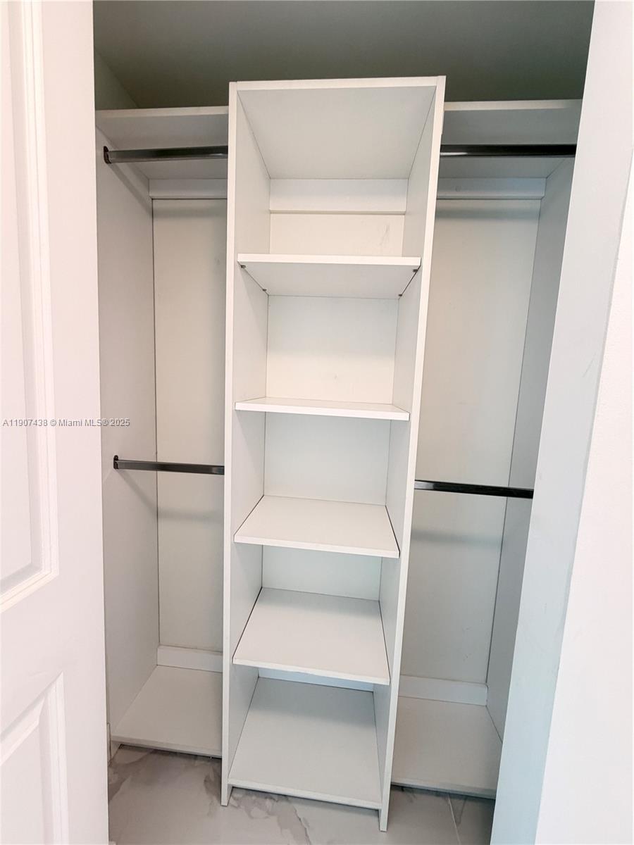 2641 North Flamingo Road, Unit 2208N Sunrise, FL 33323 - Photo 14 of 56 a view of walk in closet with empty racks