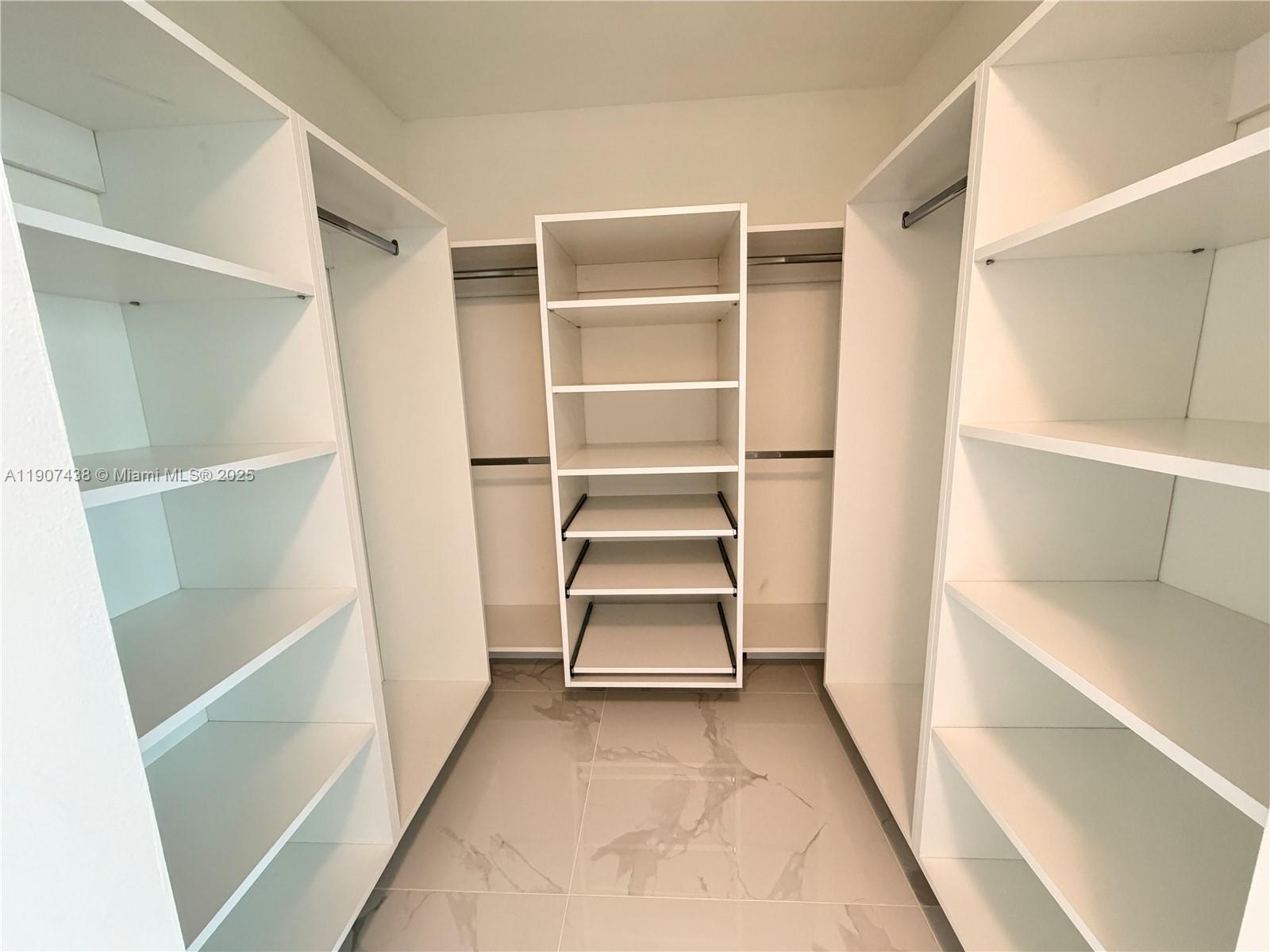 2641 North Flamingo Road, Unit 2208N Sunrise, FL 33323 - Photo 16 of 56 a view of an empty walk in closet