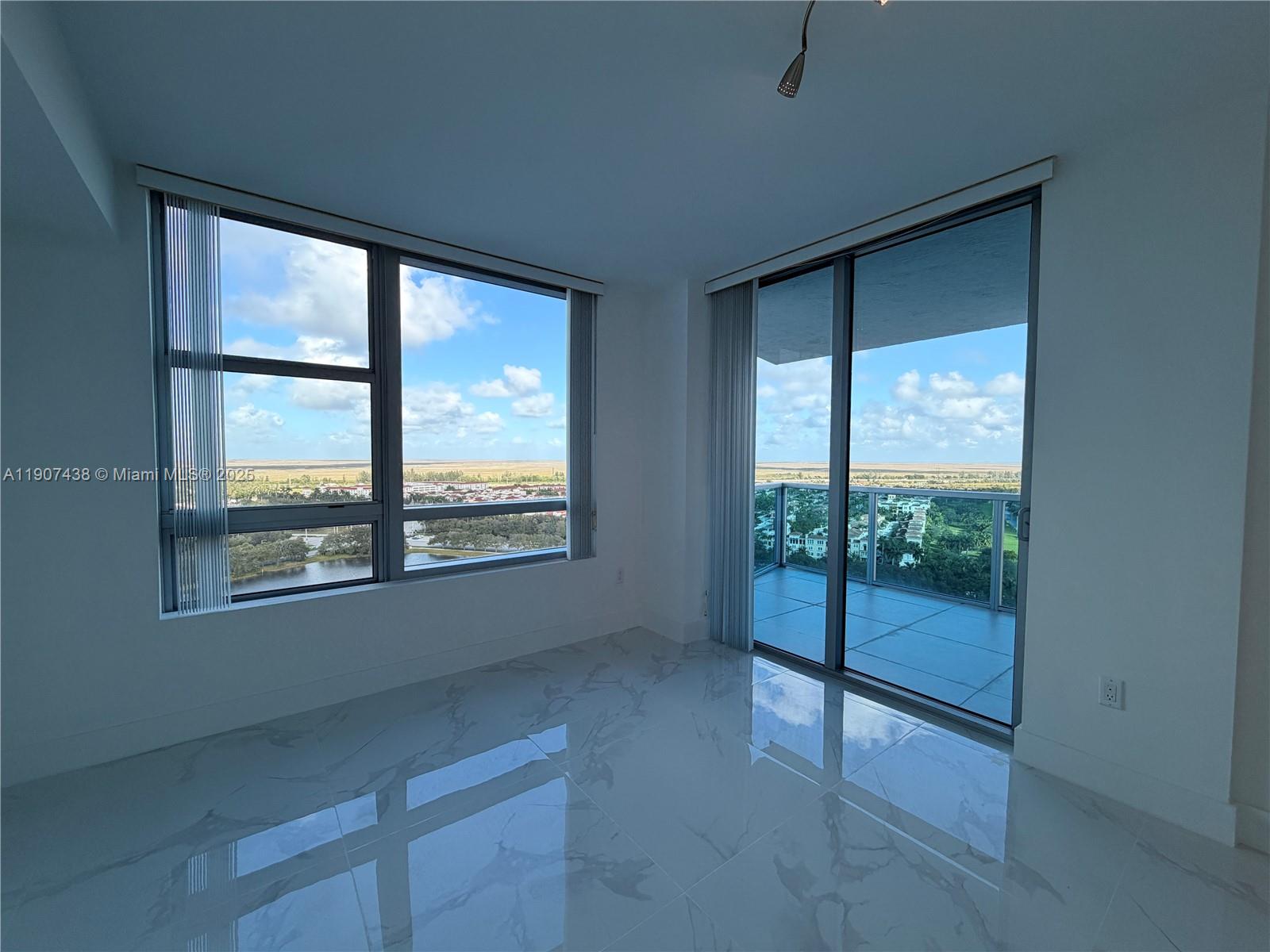 2641 North Flamingo Road, Unit 2208N Sunrise, FL 33323 - Photo 21 of 56 an empty room with wooden floor and windows