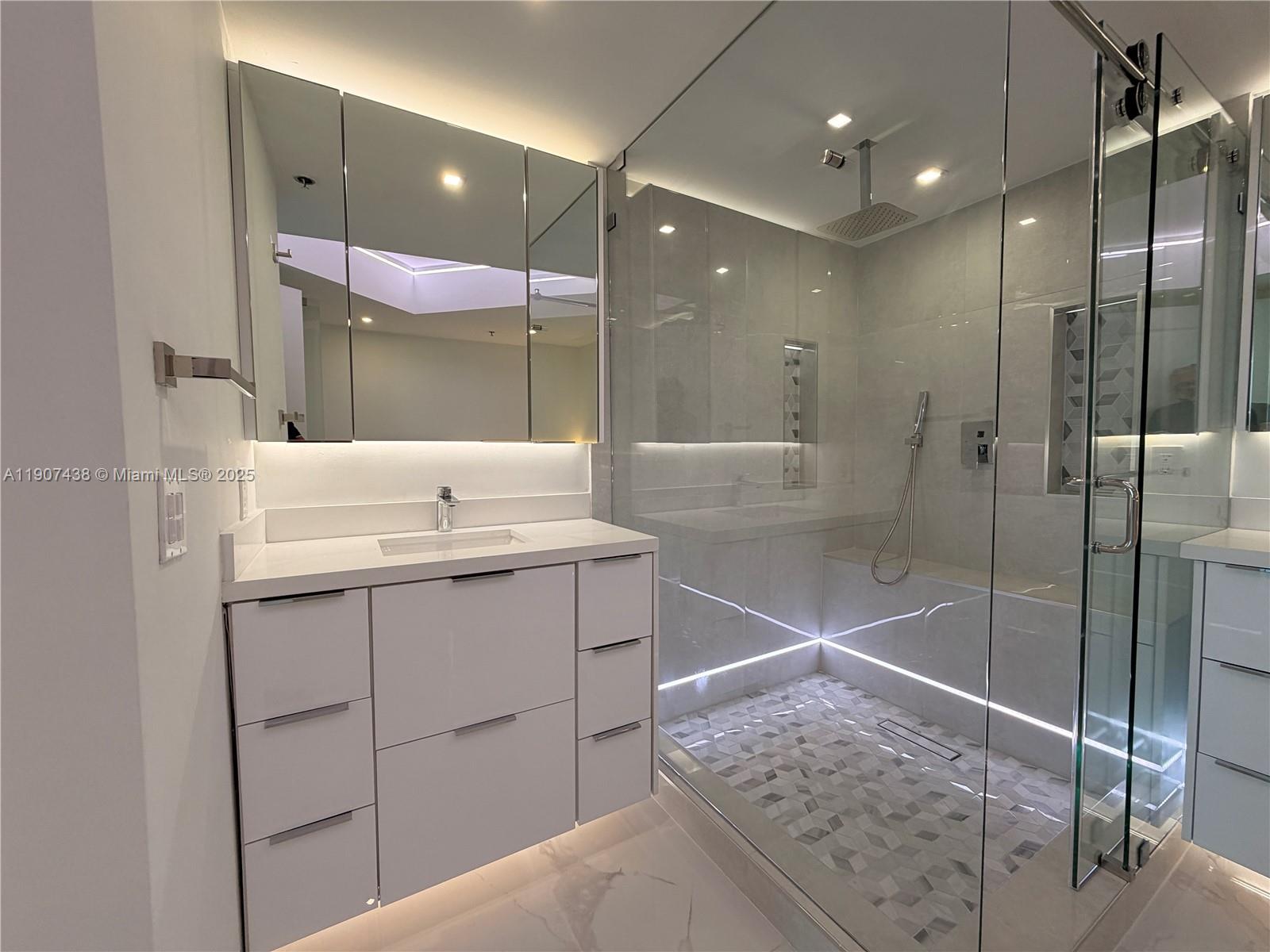 2641 North Flamingo Road, Unit 2208N Sunrise, FL 33323 - Photo 24 of 56 a bathroom with a shower sink and mirror