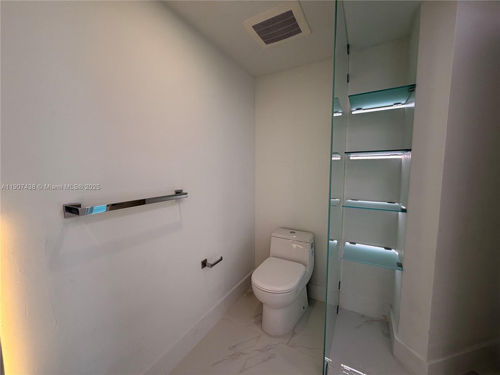 2641 North Flamingo Road, Unit 2208N Sunrise, FL 33323 - Photo 25 of 56 a white toilet sitting next to a shower