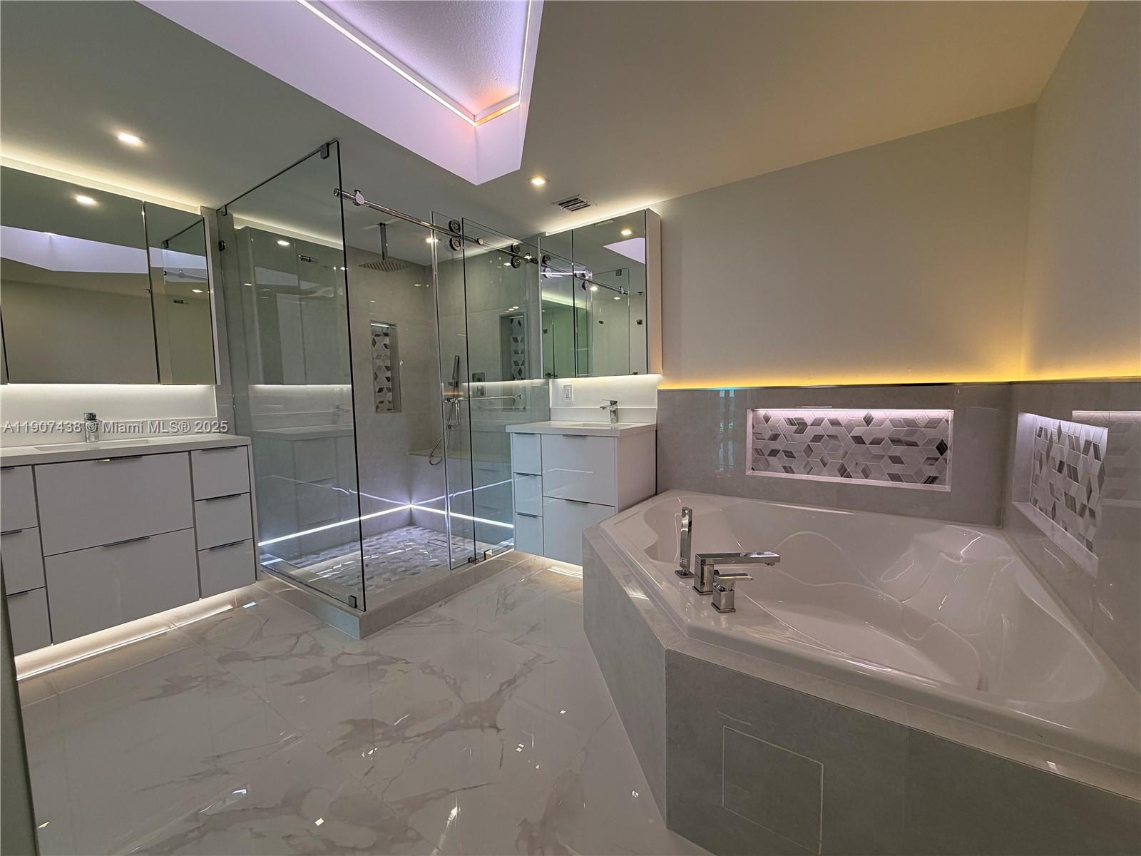 2641 North Flamingo Road, Unit 2208N Sunrise, FL 33323 - Photo 26 of 56 a spacious bathroom with a tub sink and mirror