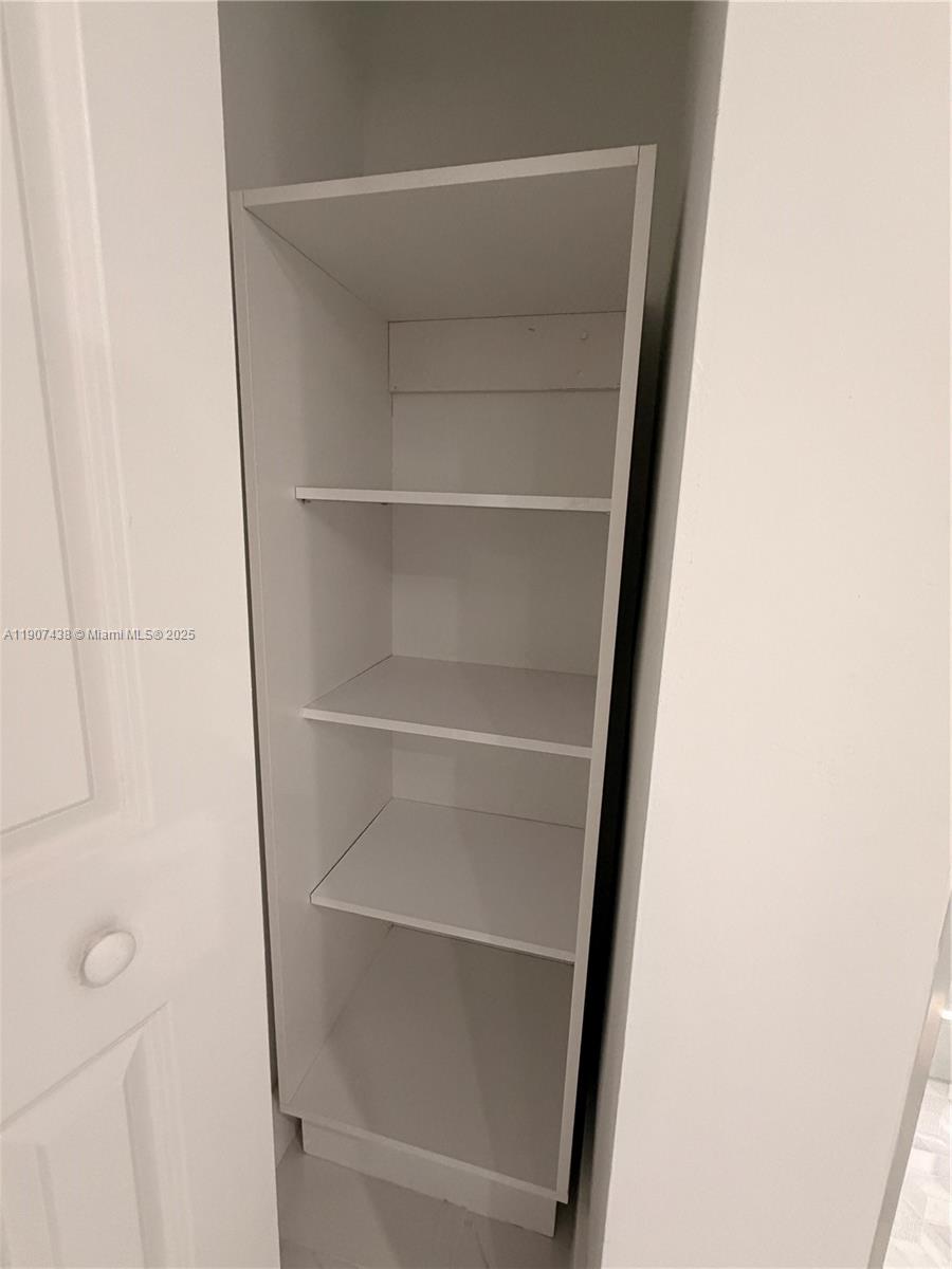 2641 North Flamingo Road, Unit 2208N Sunrise, FL 33323 - Photo 29 of 56 a view of walk in closet with empty racks