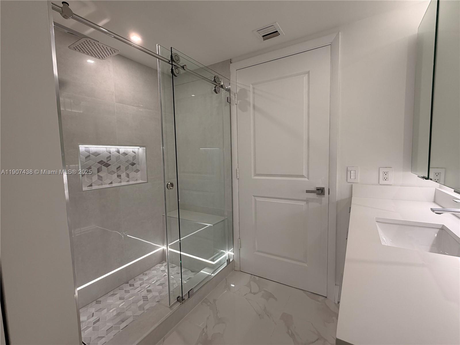 2641 North Flamingo Road, Unit 2208N Sunrise, FL 33323 - Photo 30 of 56 a bathroom with a shower and a sink