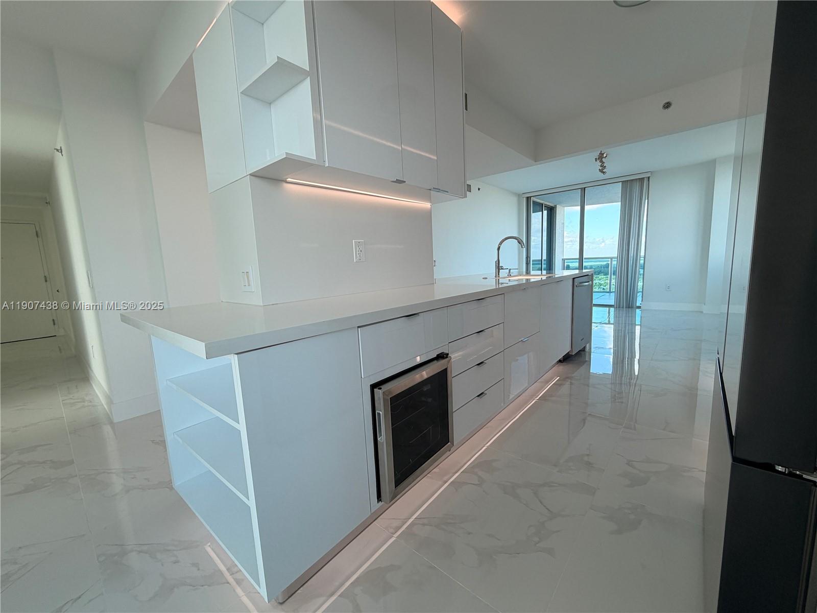 2641 North Flamingo Road, Unit 2208N Sunrise, FL 33323 - Photo 3 of 56 a large white kitchen with a stove top oven