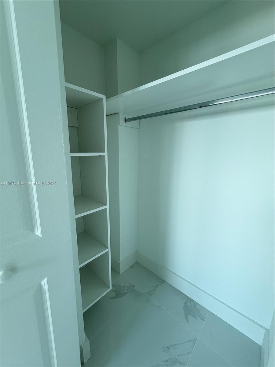 2641 North Flamingo Road, Unit 2208N Sunrise, FL 33323 - Photo 35 of 56 a view of an empty walk in closet