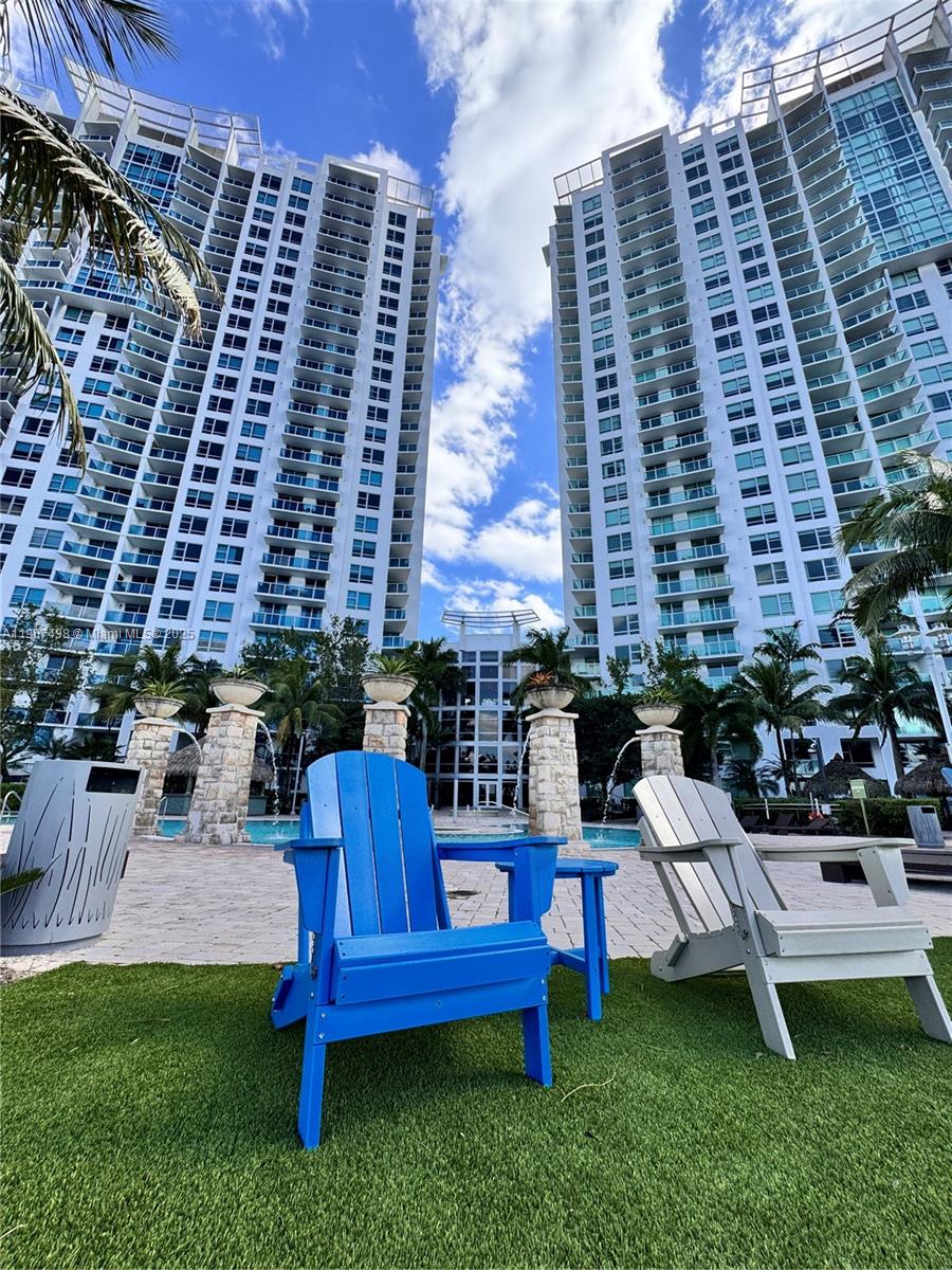2641 North Flamingo Road, Unit 2208N Sunrise, FL 33323 - Photo 40 of 56 a view of a chairs and table in back yard of the house