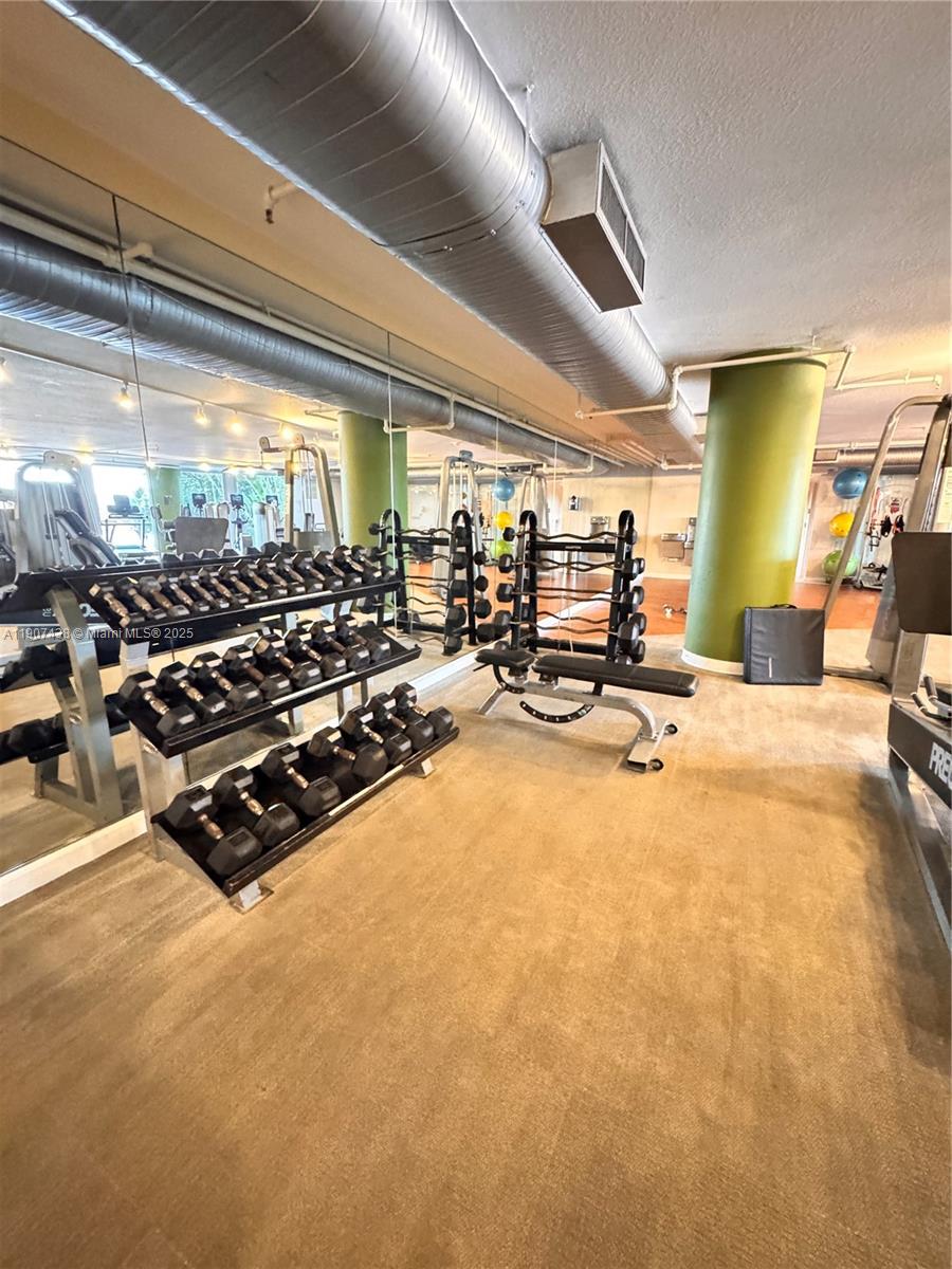 2641 North Flamingo Road, Unit 2208N Sunrise, FL 33323 - Photo 48 of 56 a room with gym equipment and large windows