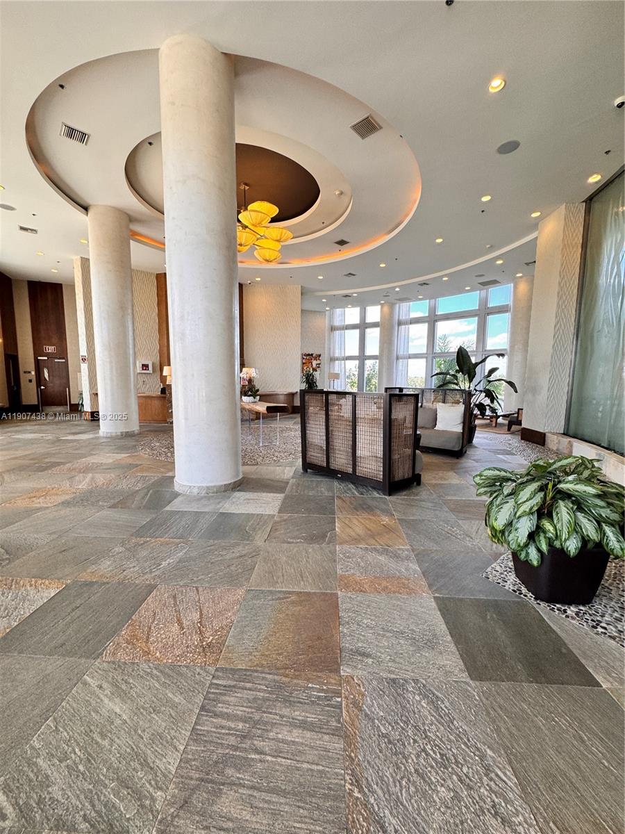 2641 North Flamingo Road, Unit 2208N Sunrise, FL 33323 - Photo 55 of 56 a lobby with furniture and a large mirror