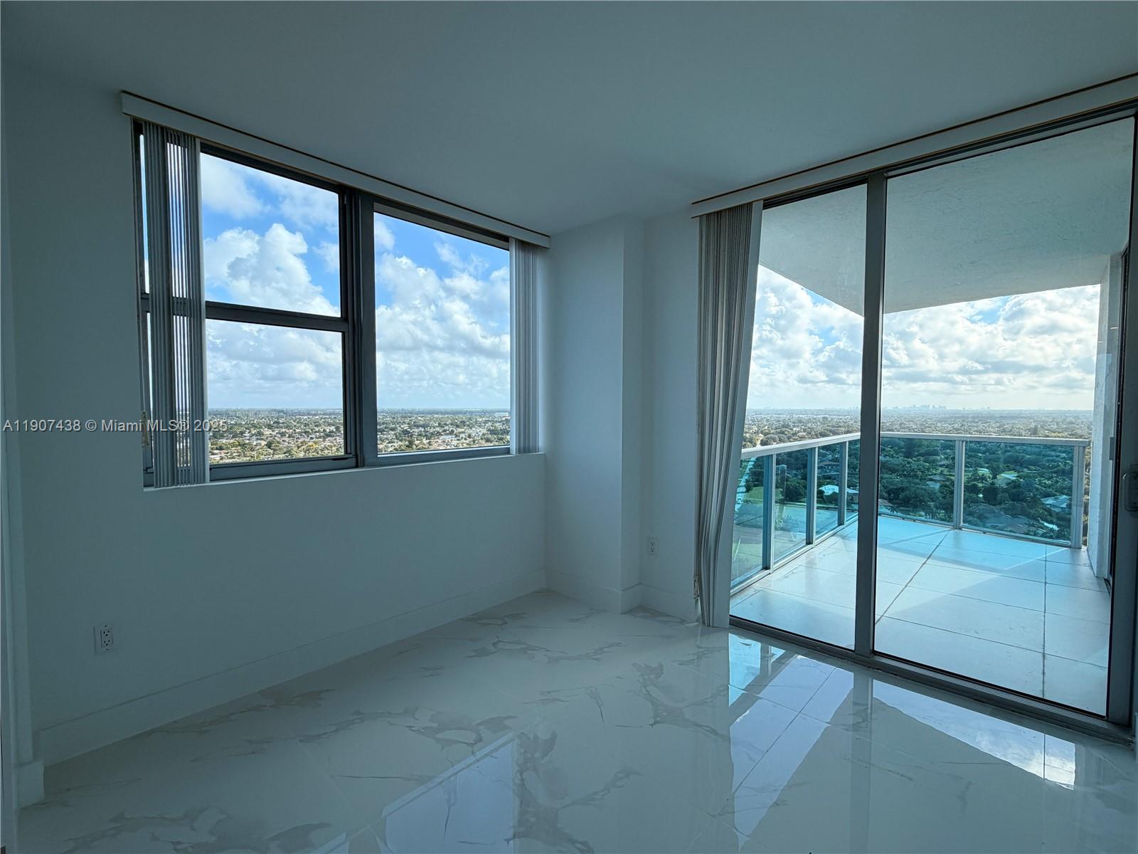2641 North Flamingo Road, Unit 2208N Sunrise, FL 33323 - Photo 7 of 56 a view of an empty room with wooden floor and a window