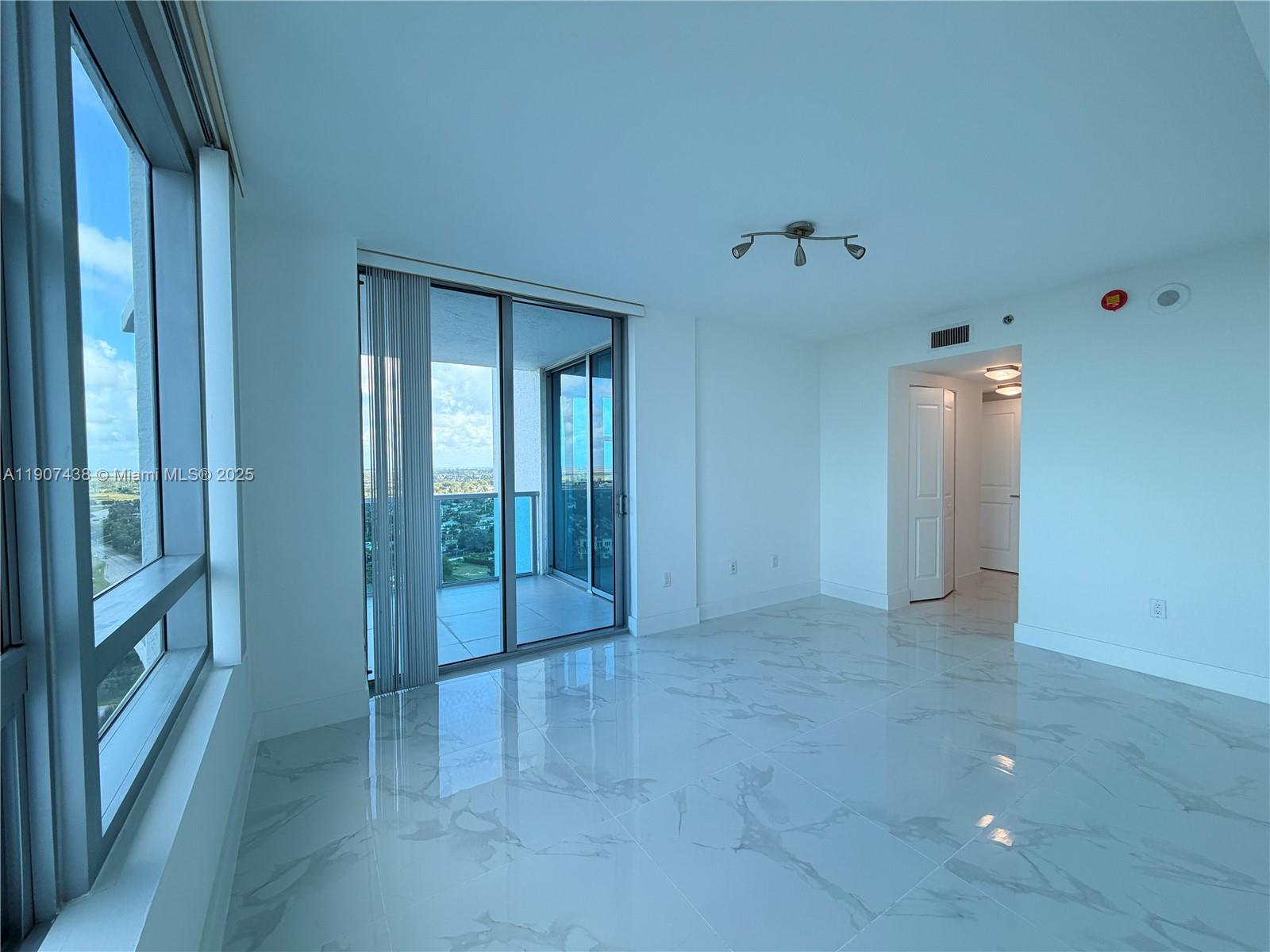 2641 North Flamingo Road, Unit 2208N Sunrise, FL 33323 - Photo 9 of 56 wooden floor and windows in an empty room