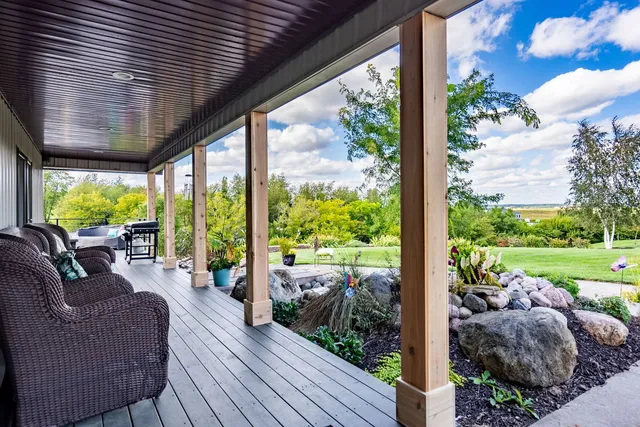 a balcony with furniture and garden view