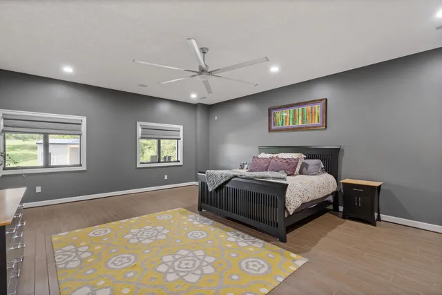 a spacious bedroom with a bed and a window