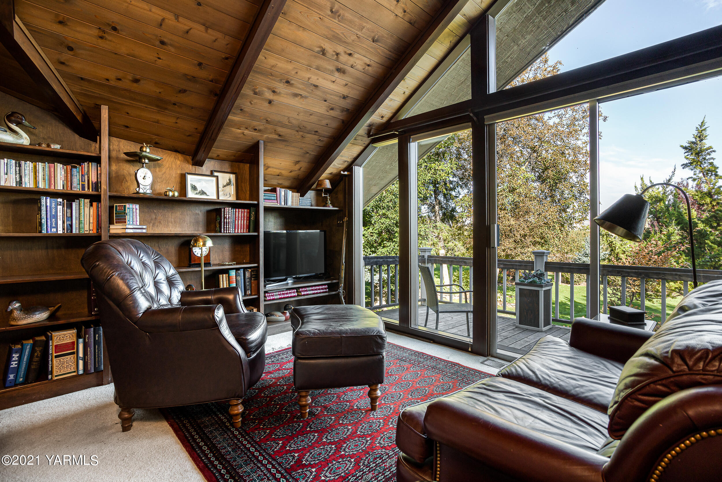 12401 Nelson Road Yakima, WA 98903 - Photo 22 of 48 a living room with furniture a flat screen tv and a floor to ceiling window