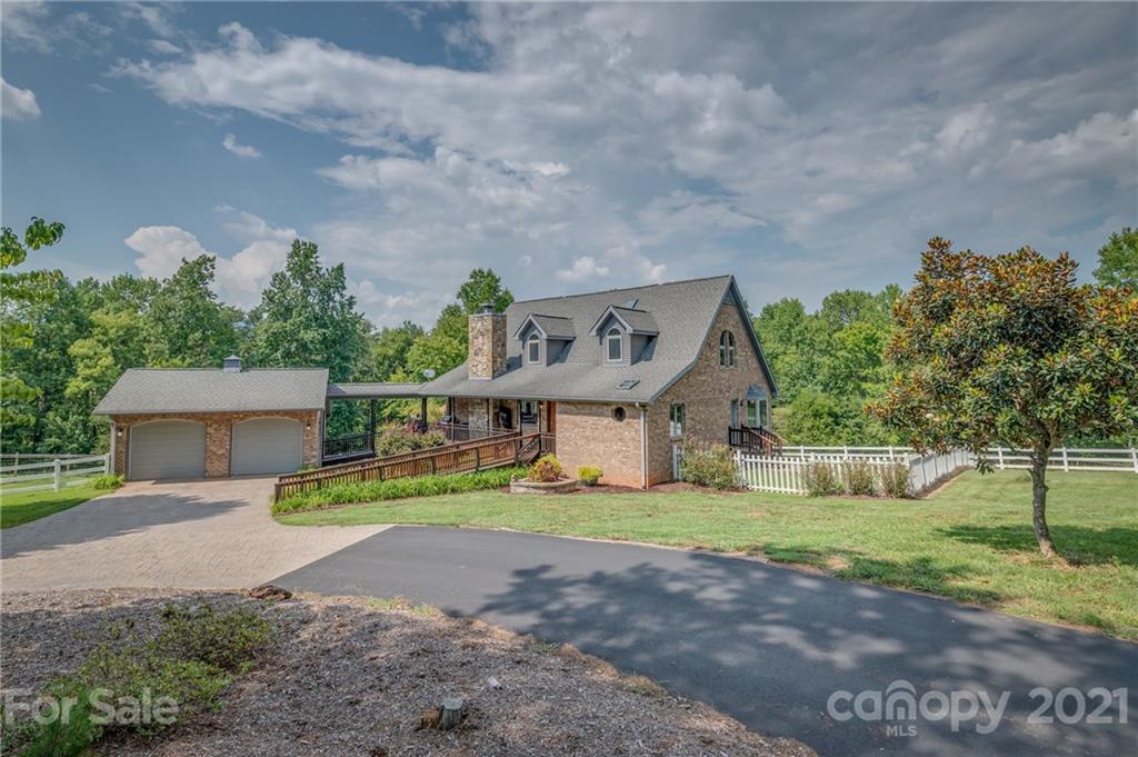2101 Peniel Road Columbus, NC 28722 - Photo 1 of 48 a front view of a house with a yard and garage