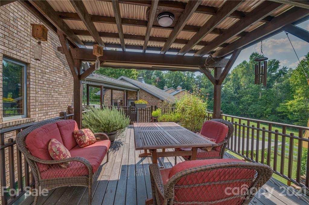 2101 Peniel Road Columbus, NC 28722 - Photo 16 of 48 a outdoor space with patio couches wooden floor and a fence