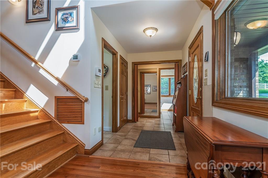 2101 Peniel Road Columbus, NC 28722 - Photo 21 of 48 a view of a hallway with wooden floor and staircase