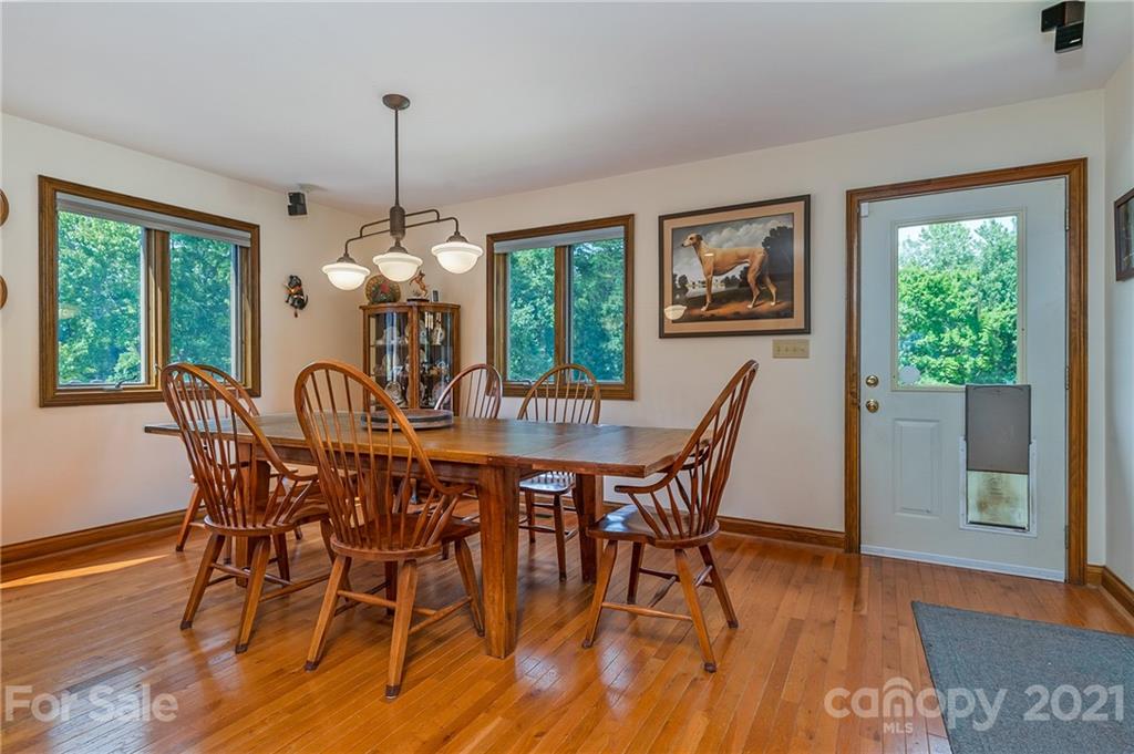 2101 Peniel Road Columbus, NC 28722 - Photo 25 of 48 a dining room with furniture window wooden floor
