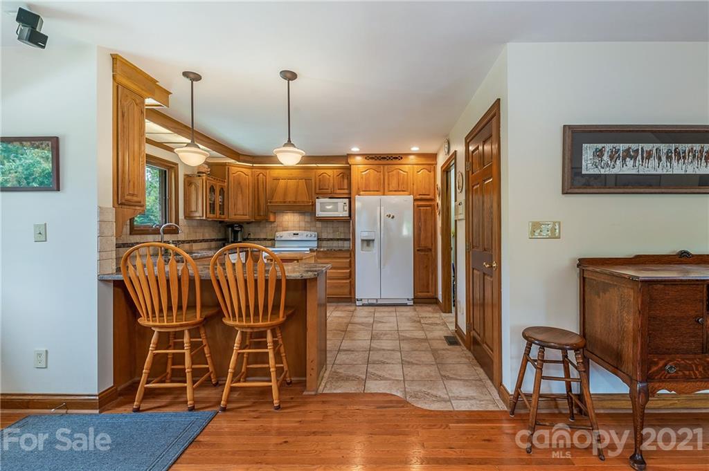 2101 Peniel Road Columbus, NC 28722 - Photo 26 of 48 a view of a dining room with furniture wooden floor and chandelier
