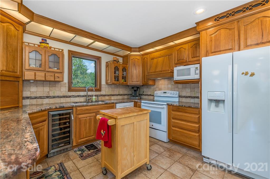 2101 Peniel Road Columbus, NC 28722 - Photo 27 of 48 a kitchen with stainless steel appliances granite countertop a sink and cabinets