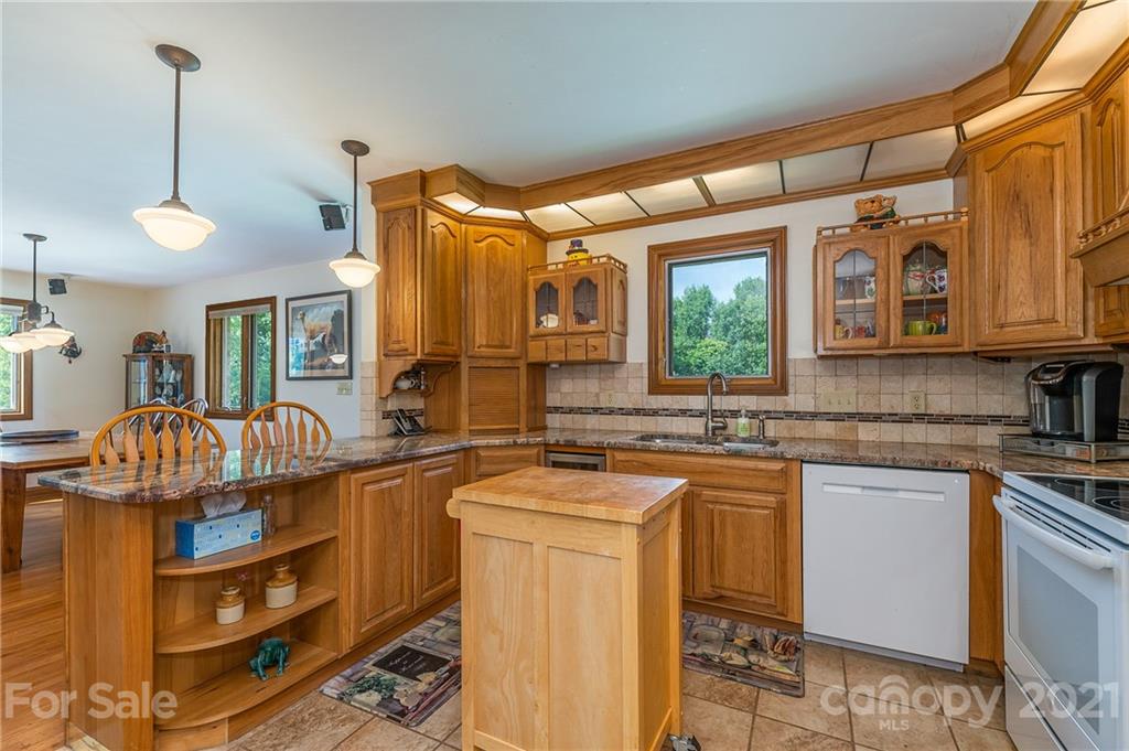 2101 Peniel Road Columbus, NC 28722 - Photo 28 of 48 a kitchen that has a lot of cabinets in it and wooden floors