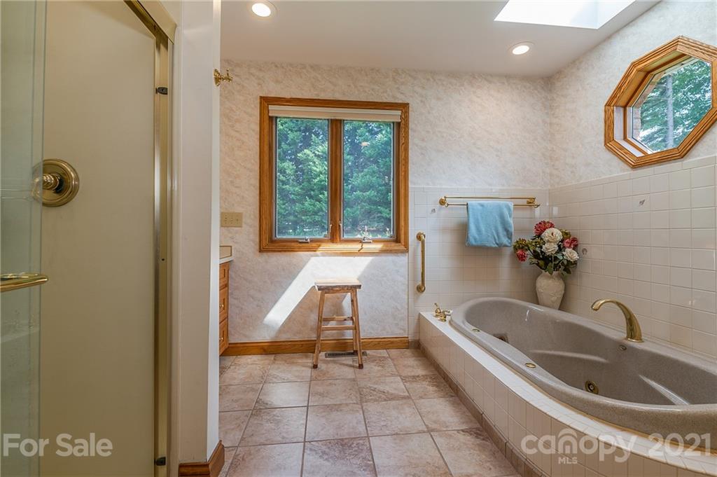 2101 Peniel Road Columbus, NC 28722 - Photo 32 of 48 a bathroom with a tub sink and mirror