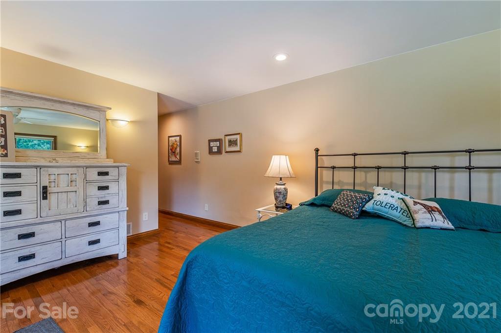 2101 Peniel Road Columbus, NC 28722 - Photo 35 of 48 a bed room with a bed and a night stand