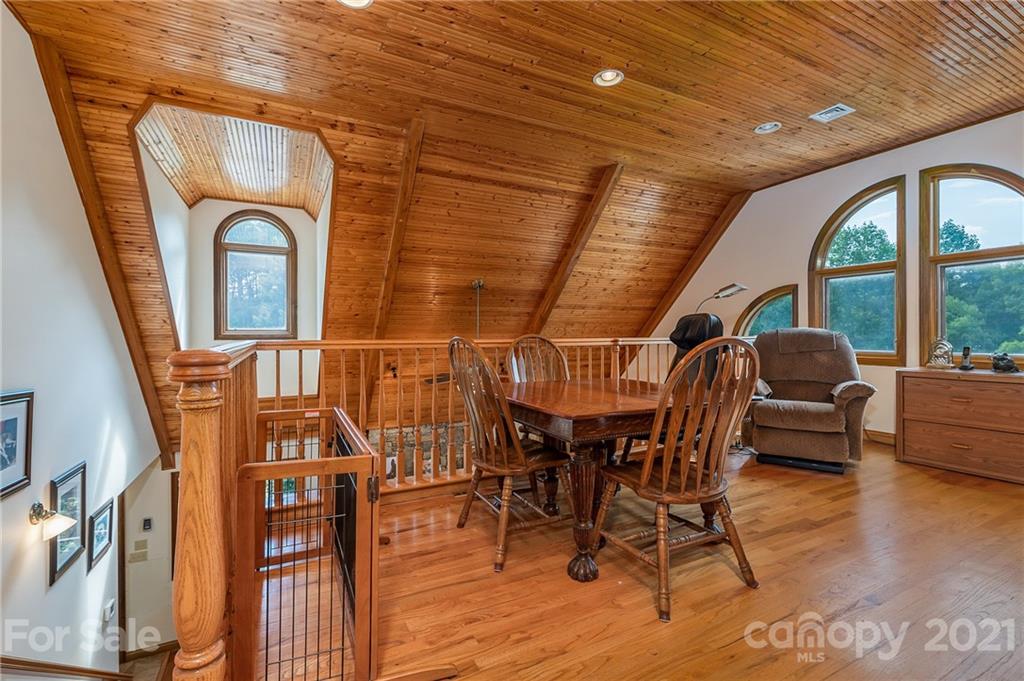 2101 Peniel Road Columbus, NC 28722 - Photo 42 of 48 a dining room with furniture window and wooden floor