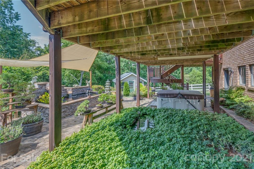 2101 Peniel Road Columbus, NC 28722 - Photo 10 of 48 a view of a porch with a floor to ceiling window and wooden fence
