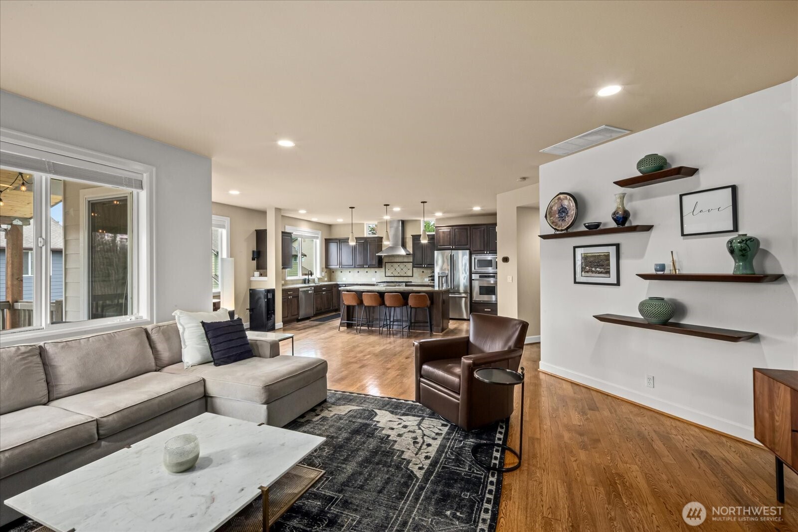 215 Ilwaco Place Southeast Renton, WA 98059 - Photo 11 of 40 a living room with furniture and a flat screen tv