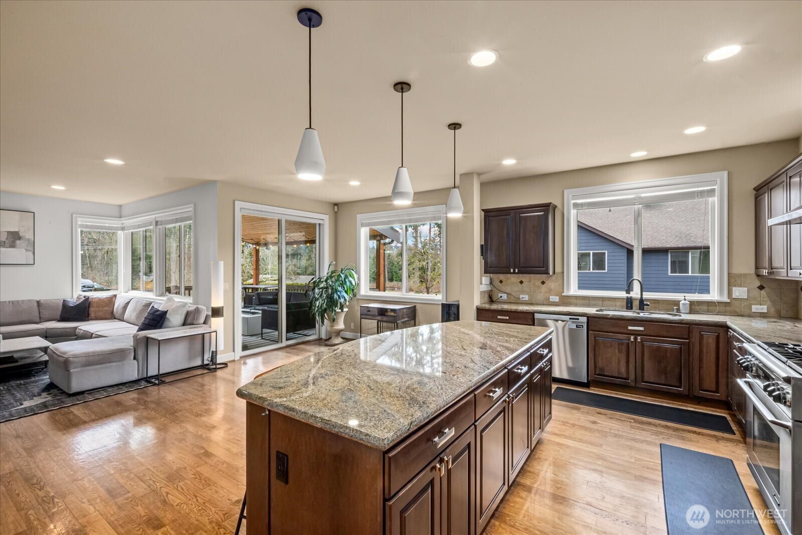 215 Ilwaco Place Southeast Renton, WA 98059 - Photo 13 of 40 a large kitchen with granite countertop a large island in the center