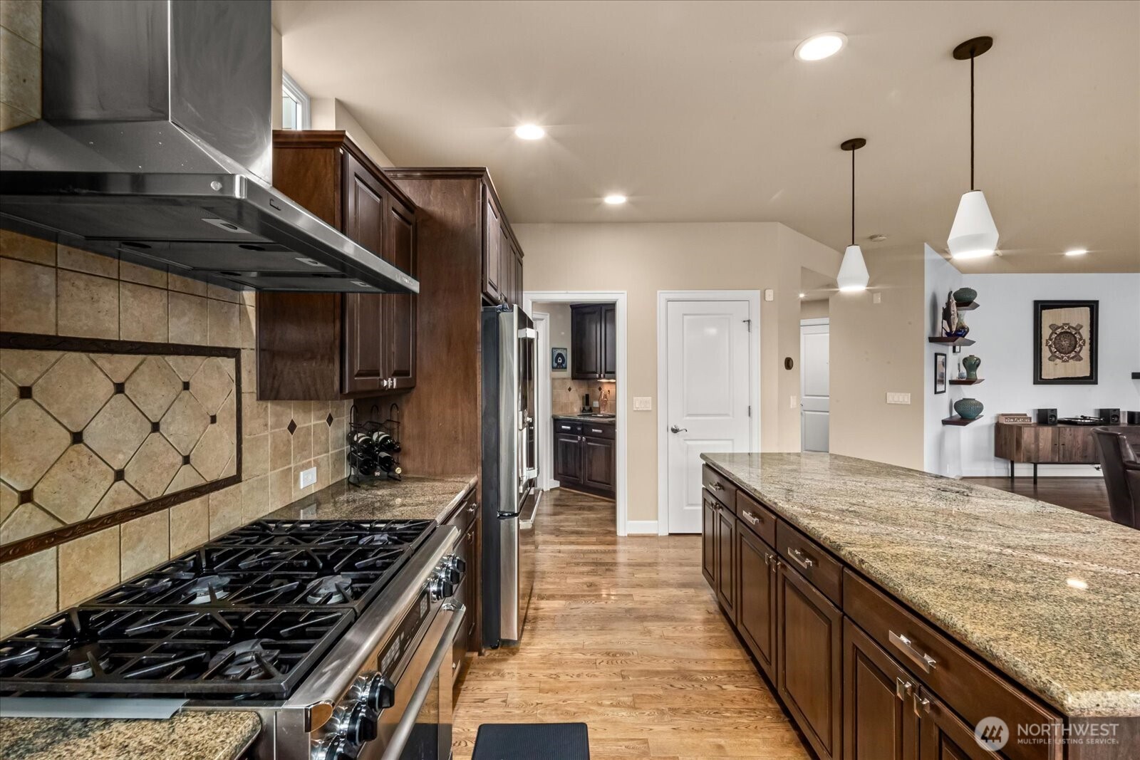 215 Ilwaco Place Southeast Renton, WA 98059 - Photo 16 of 40 a kitchen with stainless steel appliances granite countertop a stove a sink and a refrigerator