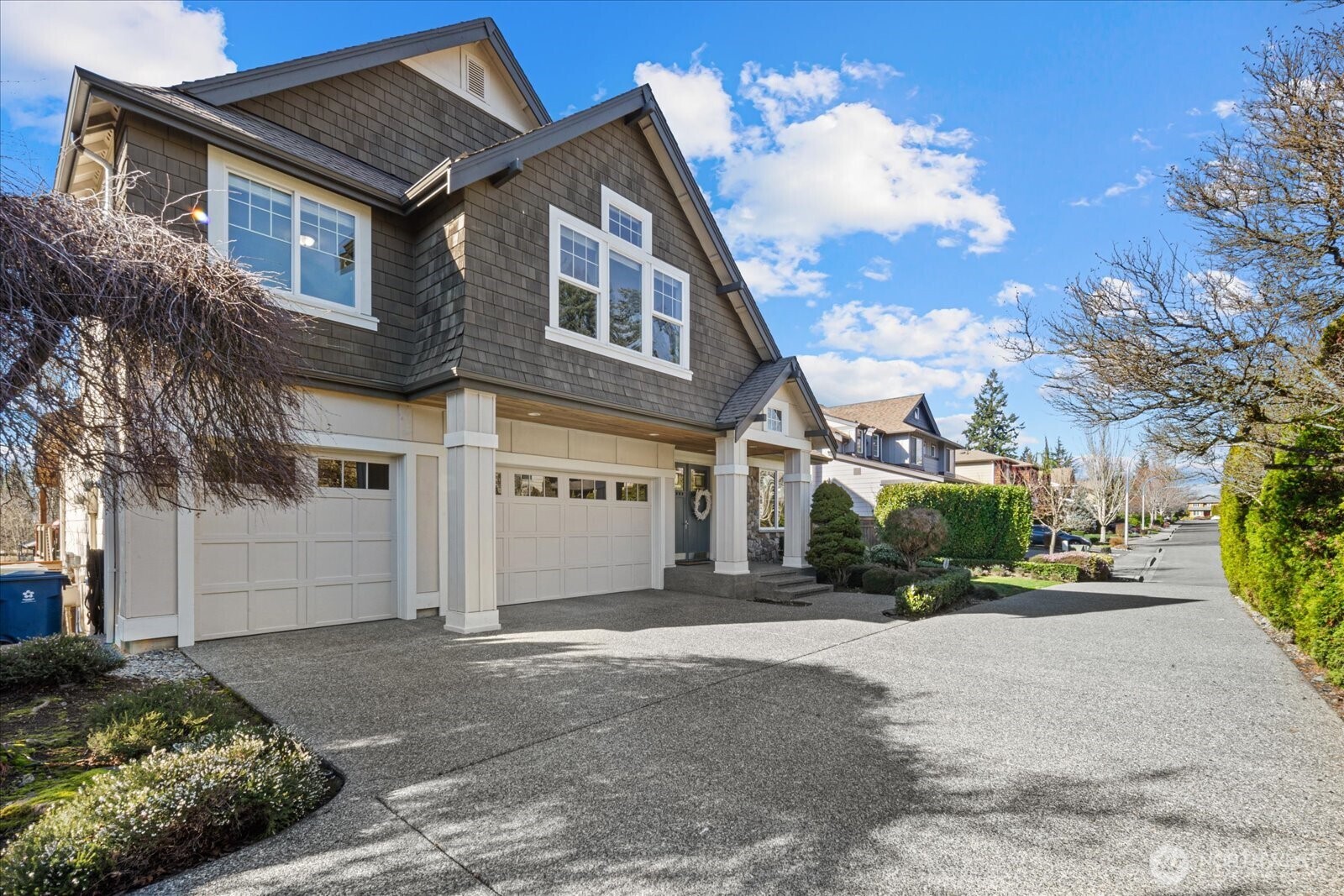 215 Ilwaco Place Southeast Renton, WA 98059 - Photo 2 of 40 a front view of a house with a yard and garage
